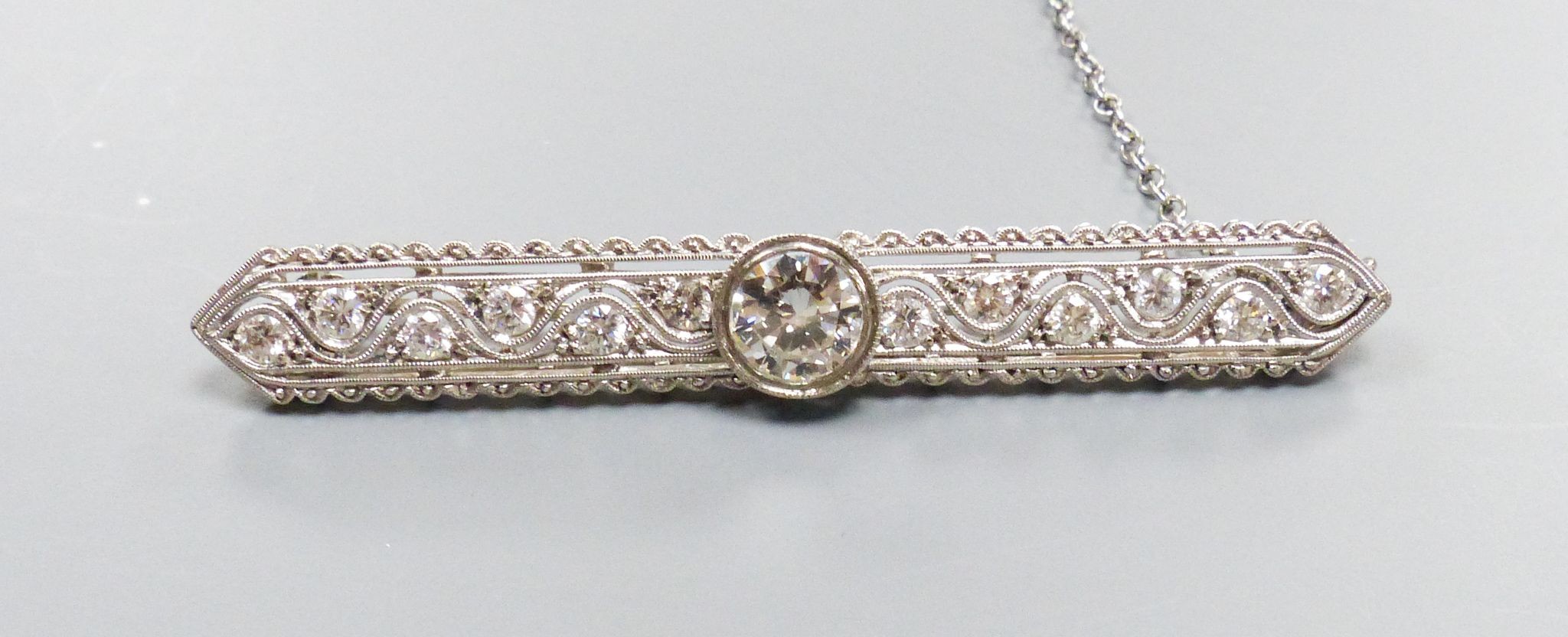 A modern Belle Epoque style pierced 750 white metal and diamond set bar brooch, 58mm, gross weight 7.6 grams